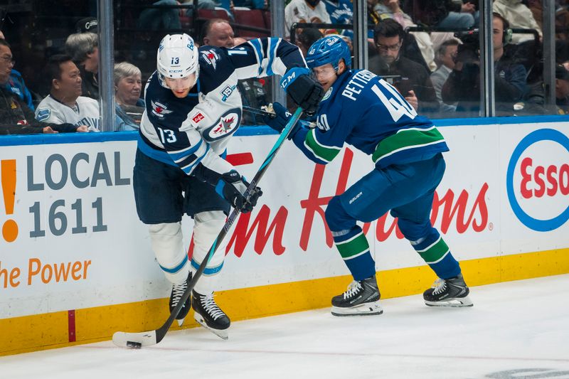 Nov 11, 2025; Vancouver, British Columbia, CAN; Vancouver Canucks forward Elias Pettersson (40) battles with Winnipeg Jets forward Gabriel Vilardi (13) in the first period at Rogers Arena. Mandatory Credit: Bob Frid-Imagn Images