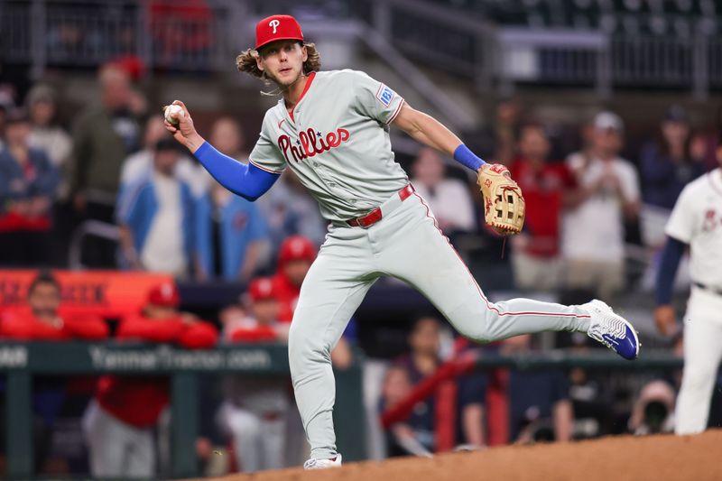 Apr 10, 2025; Atlanta, Georgia, USA; Philadelphia Phillies third baseman Alec Bohm (28) fakes a throw to first against the Atlanta Braves in the seventh inning at Truist Park. Mandatory Credit: Brett Davis-Imagn Images