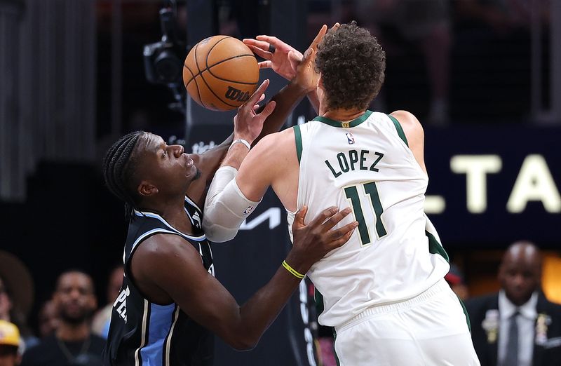 ATLANTA, GEORGIA - MARCH 30:  Brook Lopez #11 of the Milwaukee Bucks loses the ball as he drives against Clint Capela #15 of the Atlanta Hawks during the fourth quarter at State Farm Arena on March 30, 2024 in Atlanta, Georgia.  NOTE TO USER: User expressly acknowledges and agrees that, by downloading and/or using this photograph, user is consenting to the terms and conditions of the Getty Images License Agreement.  (Photo by Kevin C. Cox/Getty Images)