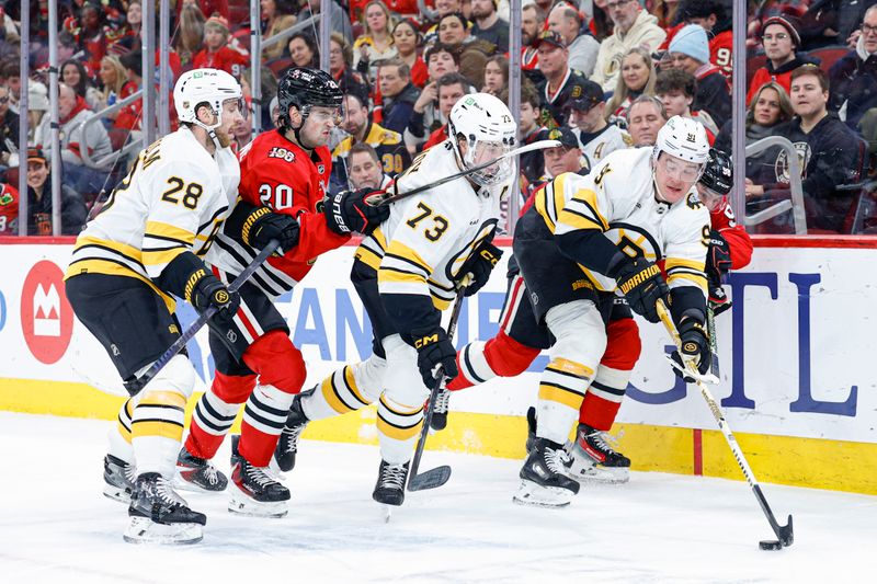 Jan 17, 2026; Chicago, Illinois, USA; Boston Bruins defenseman Nikita Zadorov (91) passes the puck away from Chicago Blackhawks center Connor Bedard (98) during the second period at United Center. Mandatory Credit: Kamil Krzaczynski-Imagn Images