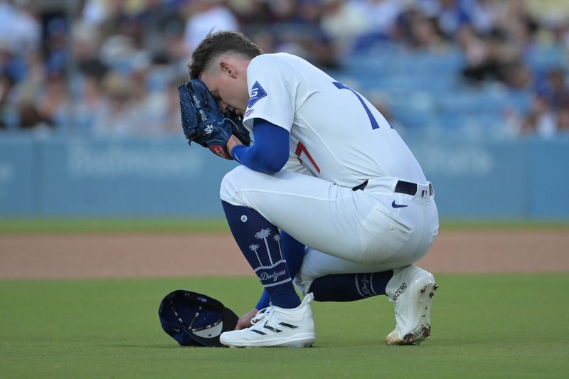 Jul 22, 2024; Los Angeles, California, USA;  Los Angeles Dodgers starting pitcher Ryan River (77) knees behind the mound prior to his first pitch for his MLB debut in the first inning against the San Francisco Giants at Dodger Stadium. Mandatory Credit: Jayne Kamin-Oncea-USA TODAY Sports