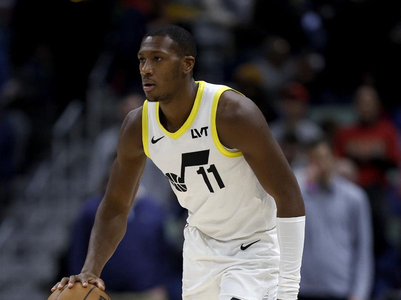 NEW ORLEANS, LOUISIANA - JANUARY 23: Kris Dunn #11 of the Utah Jazz dribbles the ball down court during the first quarter of an NBA game against the New Orleans Pelicans at Smoothie King Center on January 23, 2024 in New Orleans, Louisiana. NOTE TO USER: User expressly acknowledges and agrees that, by downloading and or using this photograph, User is consenting to the terms and conditions of the Getty Images License Agreement. (Photo by Sean Gardner/Getty Images)