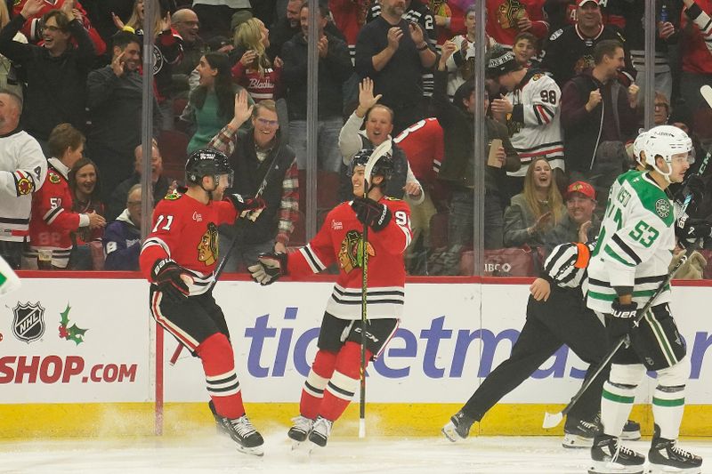 Nov 27, 2024; Chicago, Illinois, USA; Chicago Blackhawks left wing Taylor Hall (71) celebrates his goal against the Dallas Stars with Chicago Blackhawks center Connor Bedard (98) during the first period at United Center. Mandatory Credit: David Banks-Imagn Images