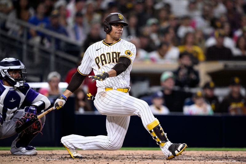 Sep 18, 2023; San Diego, California, USA; San Diego Padres left fielder Juan Soto (22) hits an RBI single against the Colorado Rockies during the fourth inning at Petco Park. Mandatory Credit: Orlando Ramirez-USA TODAY Sports