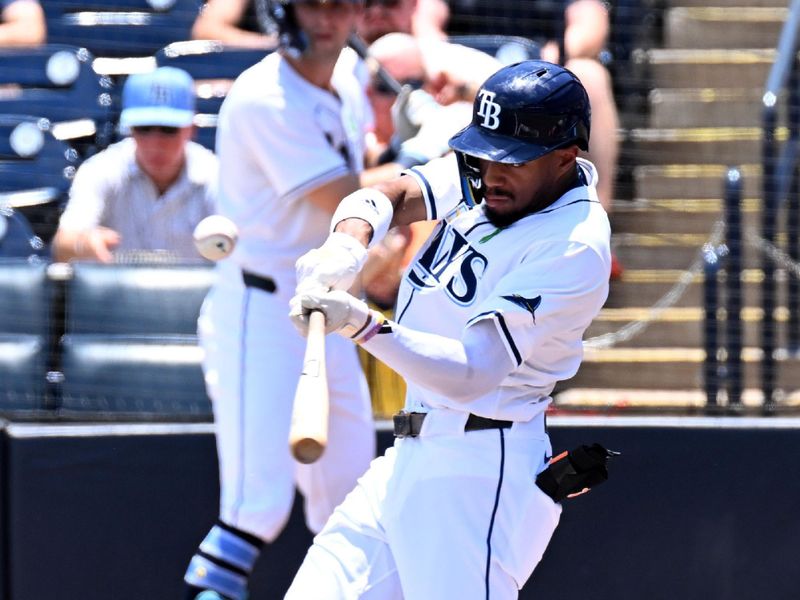  May 21, 2025; St. Petersburg, Florida, USA; Tampa Bay Rays left fielder Chandler Simpson (14) hits a RBI single in the first inning against the Houston Astros at George M. Steinbrenner Field. Mandatory Credit: Jonathan Dyer-Imagn Images