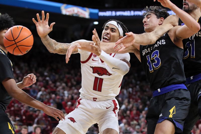 Dec 3, 2022; Fayetteville, Arkansas, USA; Arkansas Razorbacks forward Jalen Graham (11) and San Jose State Spartans guard Alvaro Cardenas (113) reach for a loose ball in the second half at Bud Walton Arena. Arkansas won 99-58. Mandatory Credit: Nelson Chenault-USA TODAY Sports