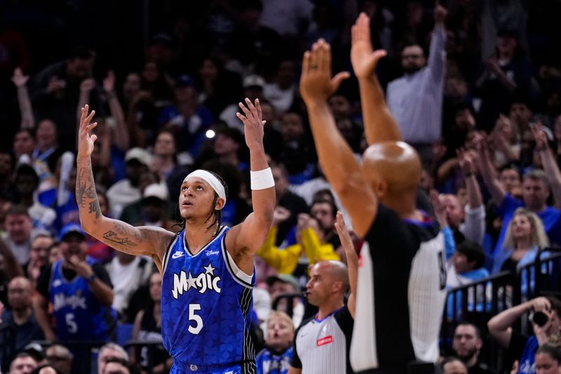 ORLANDO, FLORIDA - MARCH 29: Paolo Banchero #5 of the Orlando Magic celebrates scoring a three-pointer against the LA Clippers during the third quarter at Kia Center on March 29, 2024 in Orlando, Florida. NOTE TO USER: User expressly acknowledges and agrees that, by downloading and or using this photograph, User is consenting to the terms and conditions of the Getty Images License Agreement. (Photo by Rich Storry/Getty Images)