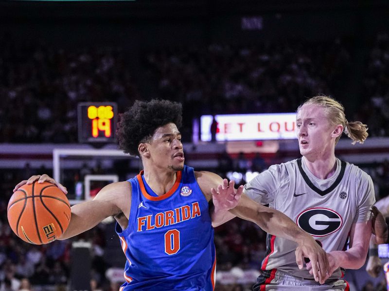 Feb 17, 2024; Athens, Georgia, USA; Florida Gators guard Zyon Pullin (0) dribbles against Georgia Bulldogs guard Blue Cain (0) during the second half at Stegeman Coliseum. Mandatory Credit: Dale Zanine-USA TODAY Sports