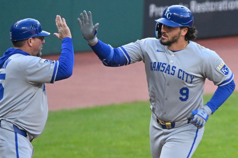 Apr 12, 2025; Cleveland, Ohio, USA; Kansas City Royals designated hitter Vinnie Pasquantino (9) celebrates his solo home run with third base coach Vance Wilson (25) in the fourth inning against the Cleveland Guardians at Progressive Field. Mandatory Credit: David Richard-Imagn Images