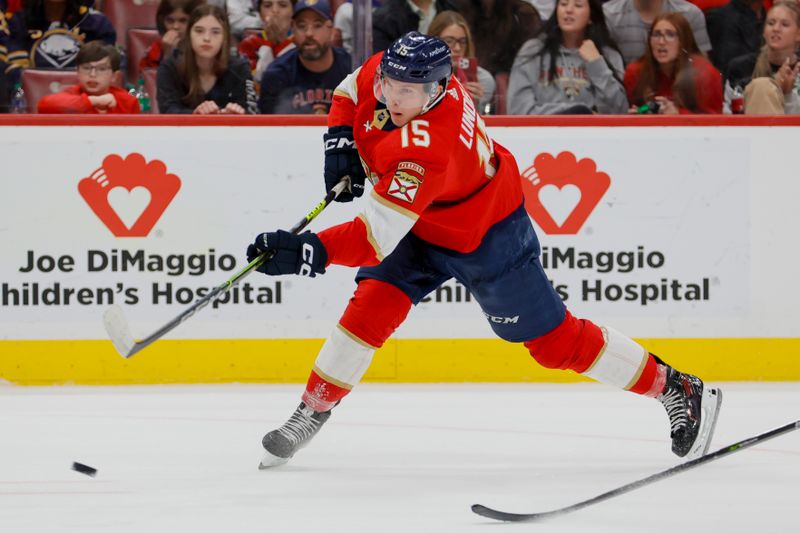 Apr 4, 2023; Sunrise, Florida, USA; Florida Panthers center Anton Lundell (15) shoots the puck during the second period against the Buffalo Sabres at FLA Live Arena. Mandatory Credit: Sam Navarro-USA TODAY Sports