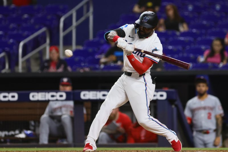 Apr 29, 2024; Miami, Florida, USA; Miami Marlins shortstop Vidal Brujan (17) hits a single against the Washington Nationals during the sixth inning at loanDepot Park. Mandatory Credit: Sam Navarro-USA TODAY Sports