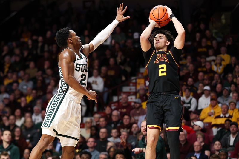 Feb 6, 2024; Minneapolis, Minnesota, USA; Minnesota Golden Gophers guard Mike Mitchell Jr. (2) shoots as Michigan State Spartans guard Tyson Walker (2) defends during the first half at Williams Arena. Mandatory Credit: Matt Krohn-USA TODAY Sports