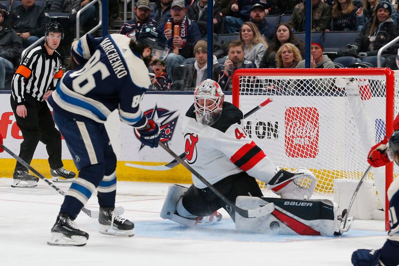 Jan 19, 2024; Columbus, Ohio, USA; New Jersey Devils goalie Vitek Vanecek (41) makes a pads save on the shot from Columbus Blue Jackets right wing Kirill Marchenko (86) during the third period at Nationwide Arena. Mandatory Credit: Russell LaBounty-USA TODAY Sports