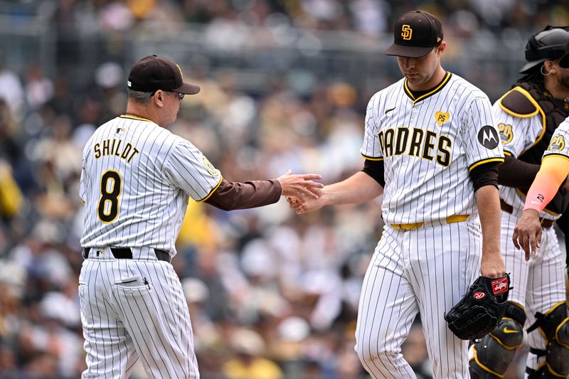 May 15, 2024; San Diego, California, USA; San Diego Padres manager Mike Shildt (8) takes the ball from starting pitcher Michael King (34) during a pitching change in the sixth inning against the Colorado Rockies at Petco Park. Mandatory Credit: Orlando Ramirez-USA TODAY Sports