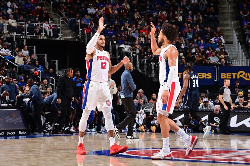 DETROIT, MI - JANUARY 1: Tobias Harris #12 and Cade Cunningham high five during the game against the Orlando Magic on January 1, 2025 at Little Caesars Arena in Detroit, Michigan. NOTE TO USER: User expressly acknowledges and agrees that, by downloading and/or using this photograph, User is consenting to the terms and conditions of the Getty Images License Agreement. Mandatory Copyright Notice: Copyright 2025 NBAE (Photo by Chris Schwegler/NBAE via Getty Images)