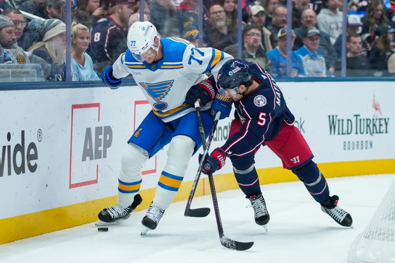 Nov 1, 2025; Columbus, Ohio, USA;  St. Louis Blues center Nick Bjugstad (77) skates with the puck against Columbus Blue Jackets defenseman Denton Mateychuk (5) in the first period at Nationwide Arena. Mandatory Credit: Aaron Doster-Imagn Images