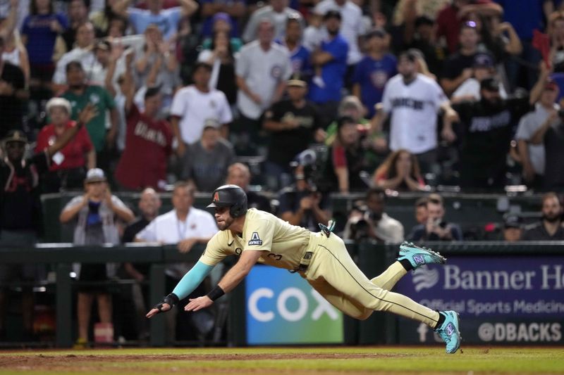 Sep 16, 2023; Phoenix, Arizona, USA; Arizona Diamondbacks pinch hitter Evan Longoria (3) slides at home and scores the game winning run against the Chicago Cubs during the 13th inning at Chase Field. Mandatory Credit: Joe Camporeale-USA TODAY Sports