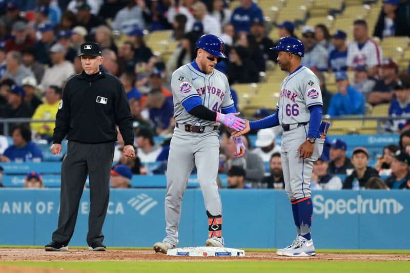 Apr 19, 2024; Los Angeles, California, USA;  New York Mets outfielder Harrison Bader (44) is greeted by first base coach Antoan Richardson (66) after hitting an RBI single during the second inning against the Los Angeles Dodgers at Dodger Stadium. Mandatory Credit: Kiyoshi Mio-USA TODAY Sports