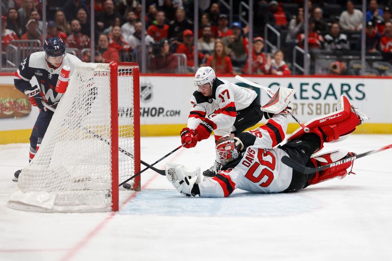 Feb 20, 2024; Washington, District of Columbia, USA; Washington Capitals center Connor McMichael (24) scores a goal on New Jersey Devils goaltender Nico Daws (50) as Devils center Chris Tierney (11) defends in the second period at Capital One Arena. Mandatory Credit: Geoff Burke-USA TODAY Sports