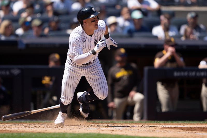 May 28, 2023; Bronx, New York, USA; New York Yankees shortstop Anthony Volpe (11) hits an RBI single against the San Diego Padres during the third inning at Yankee Stadium. Mandatory Credit: Gregory Fisher-USA TODAY Sports