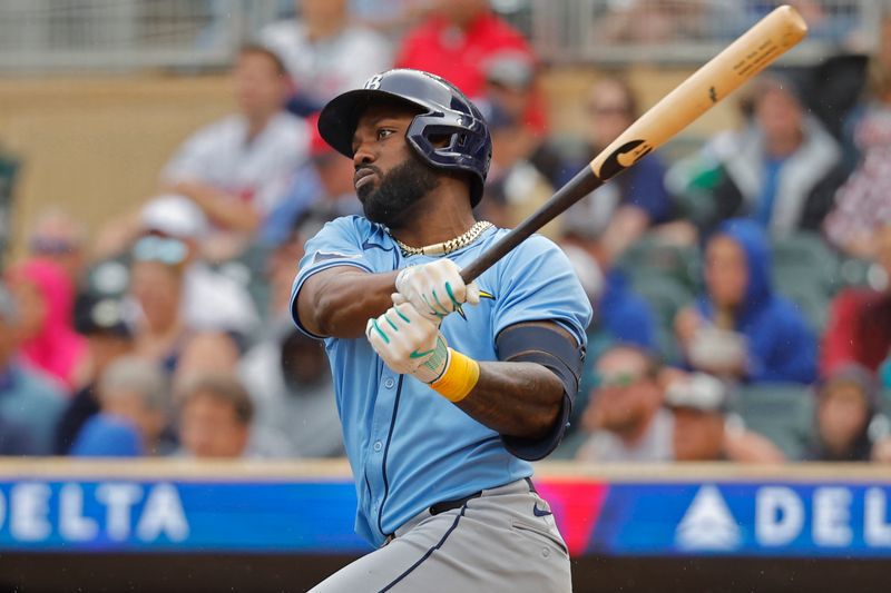 Jun 20, 2024; Minneapolis, Minnesota, USA; Tampa Bay Rays left fielder Randy Arozarena (56) follows through on his RBI double against the Minnesota Twins in the second inning at Target Field. Mandatory Credit: Bruce Kluckhohn-USA TODAY Sports