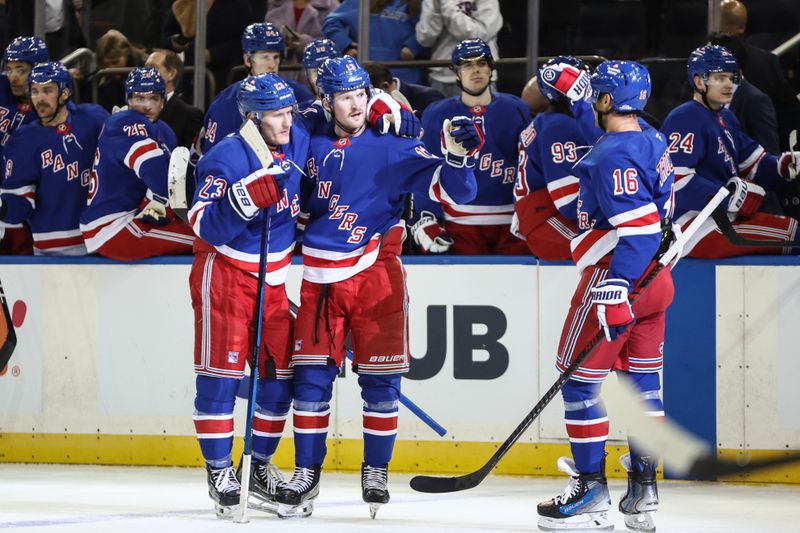 Nov 12, 2024; New York, New York, USA;  New York Rangers left wing Alexis Lafrenière (13) celebrates with his teammates after scoring a goal in the second period against the Winnipeg Jets at Madison Square Garden. Mandatory Credit: Wendell Cruz-Imagn Images