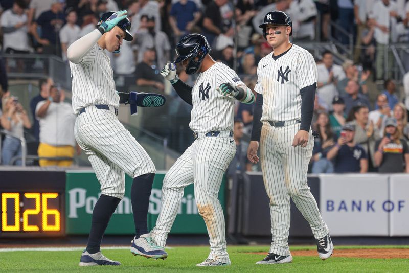 May 21, 2024; Bronx, New York, USA;  New York Yankees second baseman Gleyber Torres (25) celebrates with center fielder Aaron Judge (99) and first baseman Anthony Rizzo (48) after his three run home run during the seventh inning against the Seattle Mariners at Yankee Stadium. Mandatory Credit: Vincent Carchietta-USA TODAY Sports