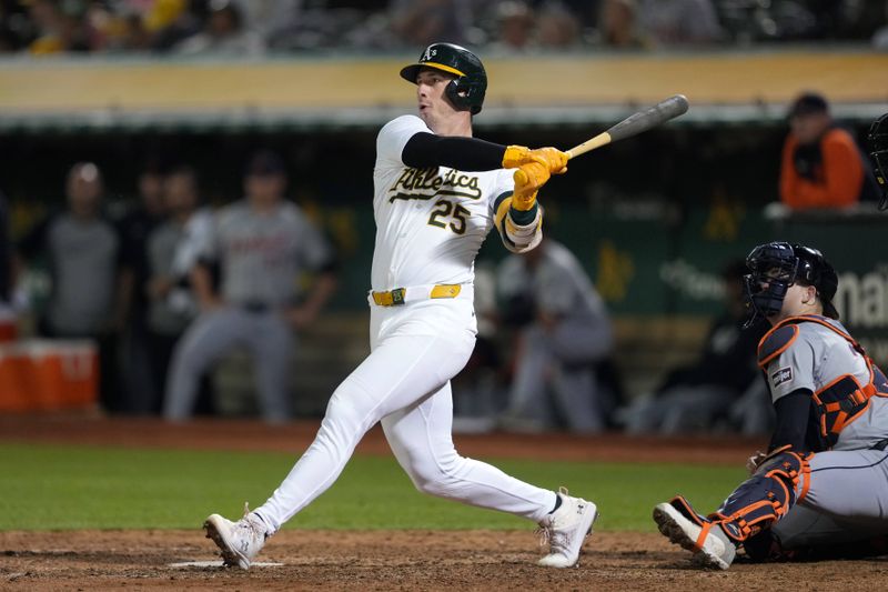 Sep 6, 2024; Oakland, California, USA; Oakland Athletics designated hitter Brent Rooker (25) hits an RBI double against the Detroit Tigers during the tenth inning at Oakland-Alameda County Coliseum. Mandatory Credit: Darren Yamashita-Imagn Images