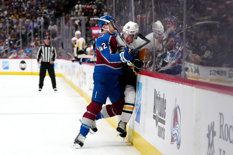 Mar 24, 2024; Denver, Colorado, USA; Colorado Avalanche defenseman Josh Manson (42) checks Pittsburgh Penguins left wing Drew O'Connor (10) in the first period at Ball Arena. Mandatory Credit: Ron Chenoy-USA TODAY Sports