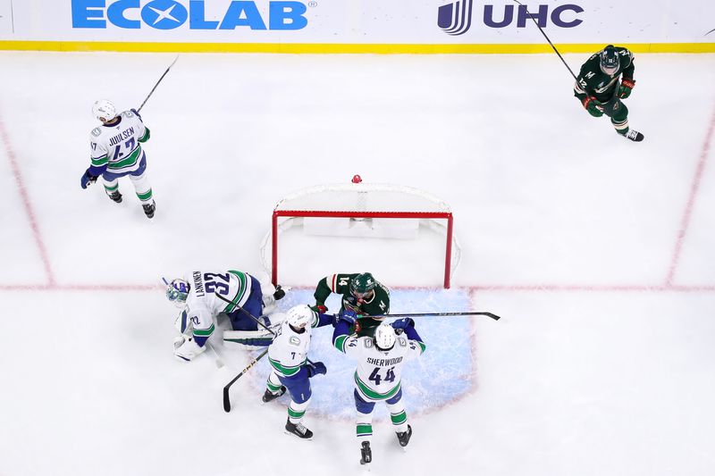 Dec 3, 2024; Saint Paul, Minnesota, USA; Minnesota Wild center Joel Eriksson Ek (14) gets into a scrum with Vancouver Canucks defenseman Carson Soucy (7) and left wing Kiefer Sherwood (44) during the first period at Xcel Energy Center. Mandatory Credit: Matt Krohn-Imagn Images