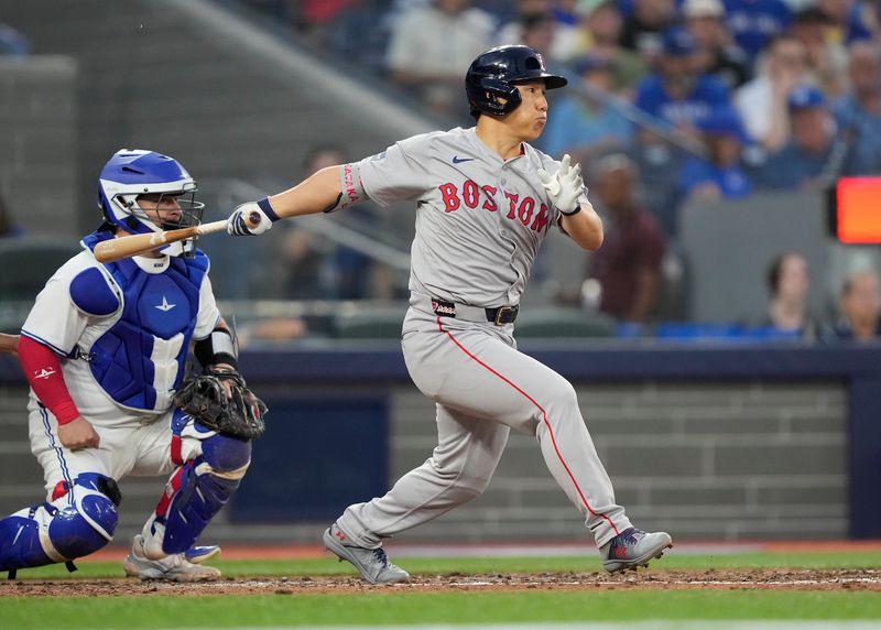 Jun 18, 2024; Toronto, Ontario, CAN; Boston Red Sox designated hitter Masataka Yoshida (7) hits a RBI single against the Toronto Blue Jays during the sixth inning at Rogers Centre. Mandatory Credit: John E. Sokolowski-USA TODAY Sports