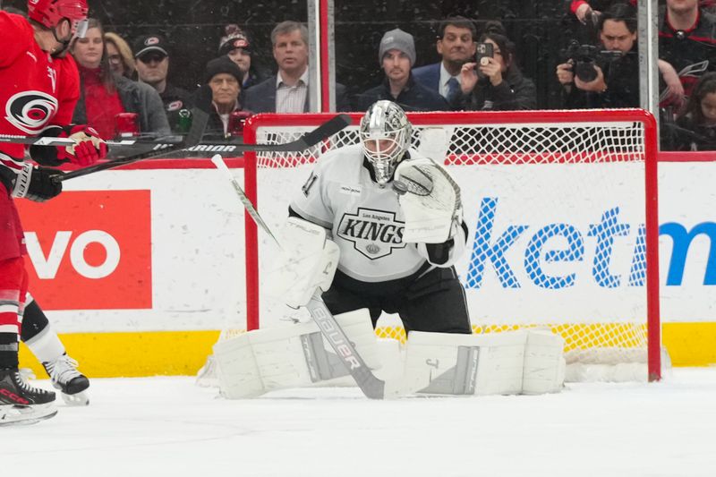 Feb 1, 2026; Raleigh, North Carolina, USA; Los Angeles Kings goaltender Anton Forsberg (31) reaches out to make a glove save against the Carolina Hurricanes during the second period at Lenovo Center. Mandatory Credit: James Guillory-Imagn Images