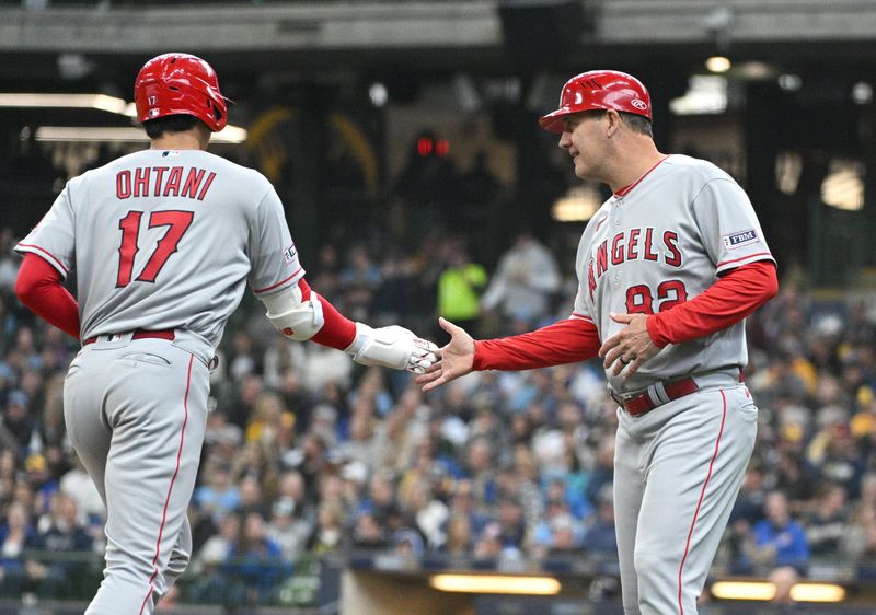 Apr 30, 2023; Milwaukee, Wisconsin, USA; Los Angeles Angels designated hitter Shohei Ohtani (17) is congratulated by third base coach Bill Haselman (82) after hitting a home run against the Milwaukee Brewers in the third inning at American Family Field. Mandatory Credit: Michael McLoone-USA TODAY Sports