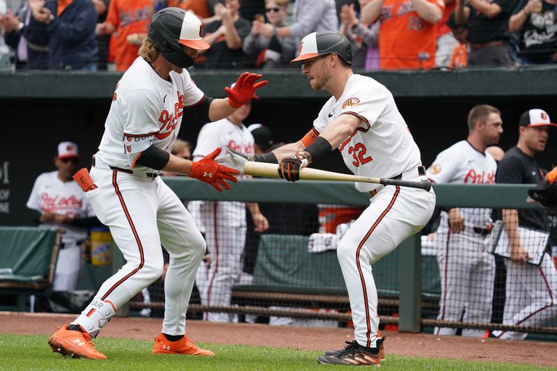 Apr 17, 2024; Baltimore, Maryland, USA; Baltimore Orioles shortstop Gunnar Henderson (2) greeted by outfielder Ryan O’Hearn (32) following his solo home run in the first inning against the Minnesota Twins at Oriole Park at Camden Yards. Mandatory Credit: Mitch Stringer-USA TODAY Sports