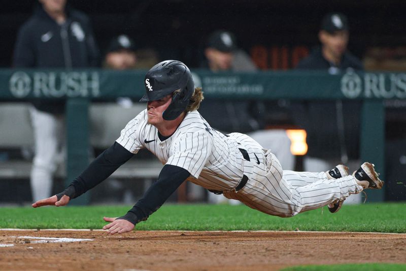 May 20, 2025; Chicago, Illinois, USA; Chicago White Sox shortstop Chase Meidroth (10) slides to score against the Seattle Mariners during the third inning at Rate Field. Mandatory Credit: Kamil Krzaczynski-Imagn Images