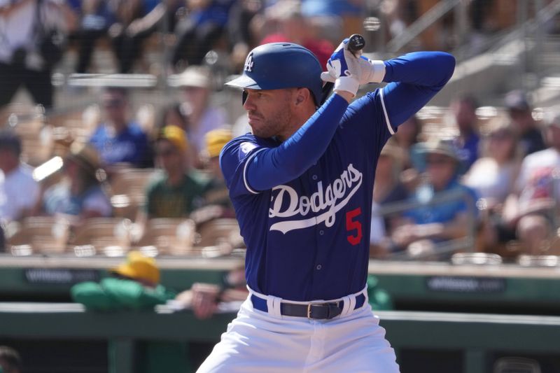 Feb 25, 2024; Phoenix, Arizona, USA; Los Angeles Dodgers first baseman Freddie Freeman (5) bats against the Oakland Athletics during the first inning at Camelback Ranch-Glendale. Mandatory Credit: Joe Camporeale-USA TODAY Sports