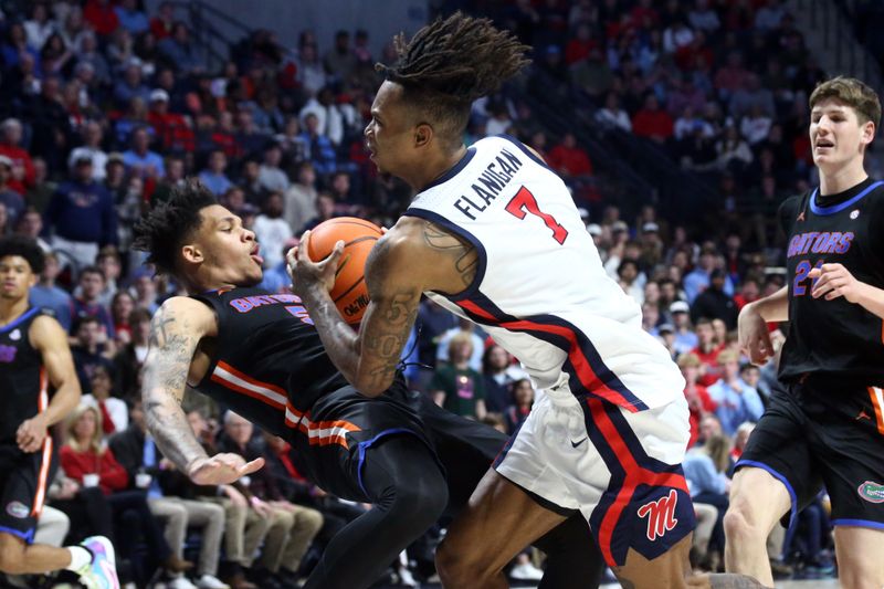 Jan 10, 2024; Oxford, Mississippi, USA; Mississippi Rebels guard Allen Flanigan (7) drives to the basket as Florida Gators guard Will Richard (5) defends during the second half at The Sandy and John Black Pavilion at Ole Miss. Mandatory Credit: Petre Thomas-USA TODAY Sports