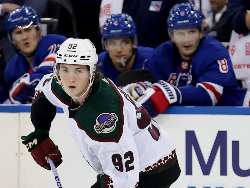 Oct 16, 2023; New York, New York, USA; Arizona Coyotes center Logan Cooley (92) skates with the puck against the New York Rangers during the first period at Madison Square Garden. Mandatory Credit: Brad Penner-USA TODAY Sports