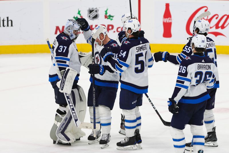 Nov 24, 2023; Sunrise, Florida, USA; Winnipeg Jets goaltender Connor Hellebuyck (37) celebrates with teammates after winning the game against the Florida Panthers at Amerant Bank Arena. Mandatory Credit: Sam Navarro-USA TODAY Sports