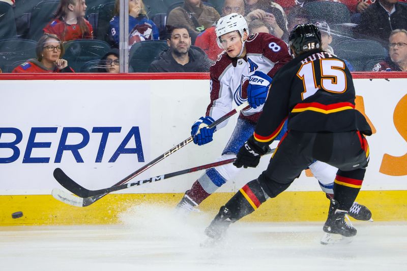 Mar 12, 2024; Calgary, Alberta, CAN; Colorado Avalanche defenseman Cale Makar (8) and Calgary Flames left wing Dryden Hunt (15) battles for the puck during the third period at Scotiabank Saddledome. Mandatory Credit: Sergei Belski-USA TODAY Sports