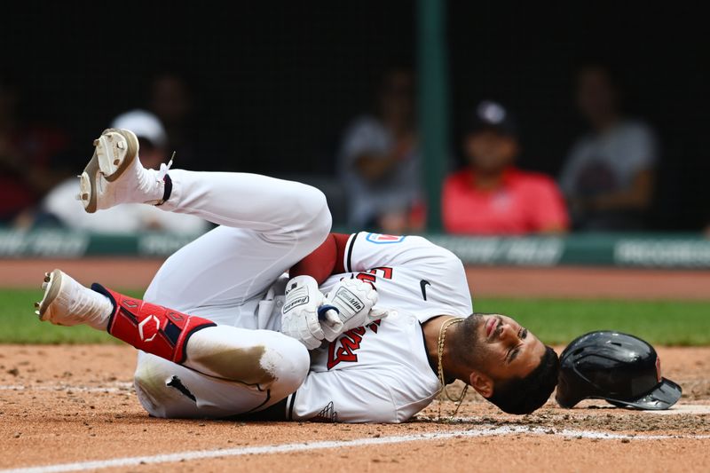 Jul 25, 2024; Cleveland, Ohio, USA; Cleveland Guardians shortstop Brayan Rocchio (4) lies on the ground after being hit by a pitch during the eighth inning against the Detroit Tigers at Progressive Field. Mandatory Credit: Ken Blaze-USA TODAY Sports