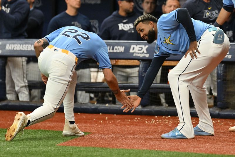 Sep 22, 2024; St. Petersburg, Florida, USA; Tampa Bay Rays pinch runner Jose Siri (22) is greeted by third baseman Junior Caminero (13) after scoring a run in the seventh inning against the Toronto Blue Jays at Tropicana Field. Mandatory Credit: Jonathan Dyer-Imagn Images