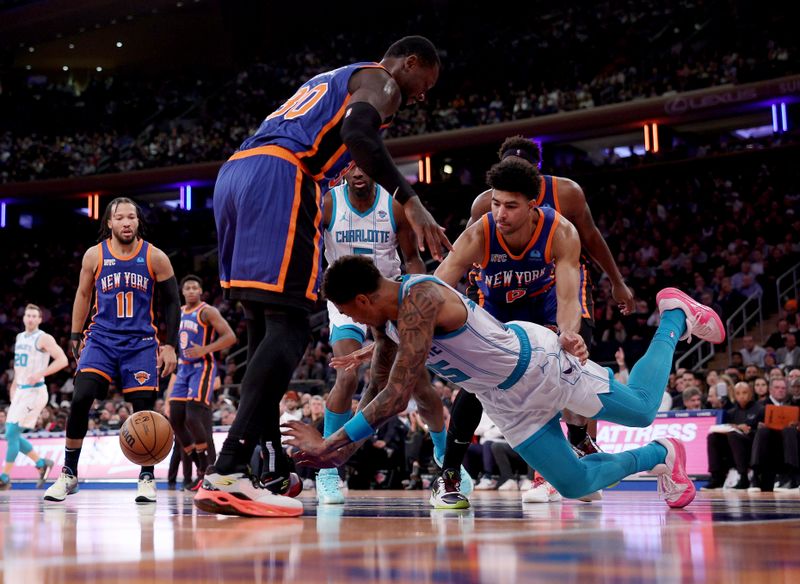 NEW YORK, NEW YORK - NOVEMBER 28:  P.J. Washington #25 of the Charlotte Hornets falls as he loses control of the ball as Julius Randle #30 and Quentin Grimes #6 of the New York Knicks defend during the second half of an NBA In-Season Tournament game at Madison Square Garden on November 28, 2023 in New York City. The New York Knicks defeated the Charlotte Hornets 115-91.NOTE TO USER: User expressly acknowledges and agrees that, by downloading and or using this photograph, User is consenting to the terms and conditions of the Getty Images License Agreement. (Photo by Elsa/Getty Images)