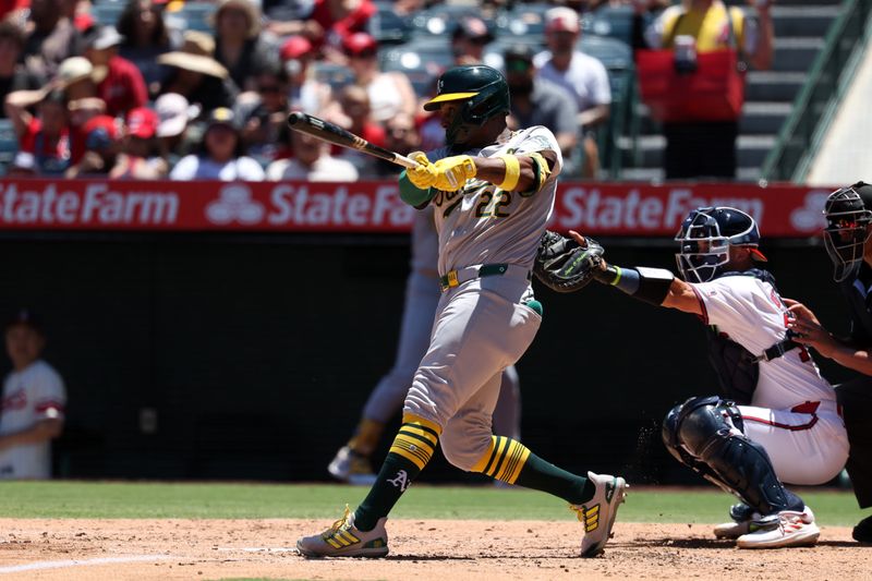 Jul 28, 2024; Anaheim, California, USA;  Oakland Athletics left fielder Miguel Andujar (22) hits an RBI fielder's choice during the third inning against the Los Angeles Angels at Angel Stadium. Mandatory Credit: Kiyoshi Mio-USA TODAY Sports