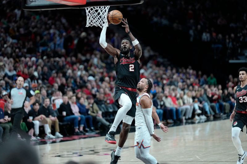 PORTLAND, OREGON - MARCH 14: Deandre Ayton #2 of the Portland Trail Blazers goes up for a dunk against Jalen Brunson #11 of the New York Knicks during the second half at Moda Center on March 14, 2024 in Portland, Oregon. NOTE TO USER: User expressly acknowledges and agrees that, by downloading and or using this photograph, User is consenting to the terms and conditions of the Getty Images License Agreement.  (Photo by Soobum Im/Getty Images)