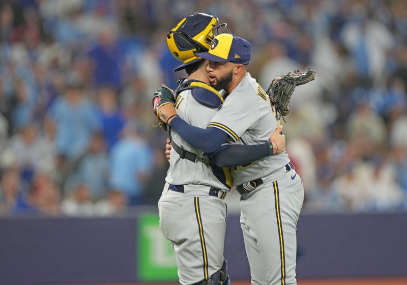 May 31, 2023; Toronto, Ontario, CAN; Milwaukee Brewers relief pitcher Devin Williams (38) celebrates a win with catcher Victor Caratini (7) against the Toronto Blue Jays at the end of the ninth inning at Rogers Centre. Mandatory Credit: Nick Turchiaro-USA TODAY Sports