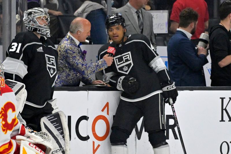 Apr 11, 2024; Los Angeles, California, USA;  Daryl Evans, radio color commentator for the Los Angeles Kings, talks with center Akil Thomas (41) prior to the game against the Calgary Flames at Crypto.com Arena. Mandatory Credit: Jayne Kamin-Oncea-USA TODAY Sports