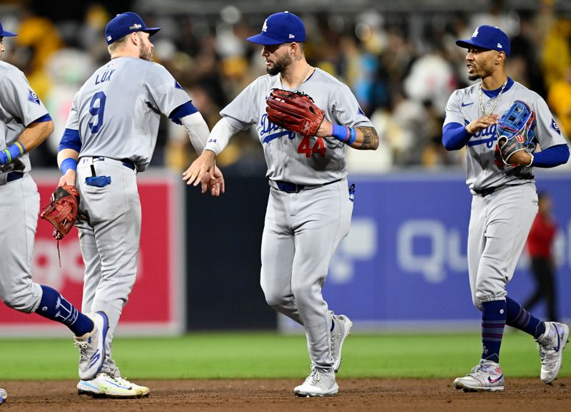 Oct 9, 2024; San Diego, California, USA; Los Angeles Dodgers outfielder Andy Pages (44) and shortstop Mookie Betts (50) celebrate with teammates after winning game four of the NLDS for the 2024 MLB Playoffs against the San Diego Padres at Petco Park.  Mandatory Credit: Denis Poroy-Imagn Images