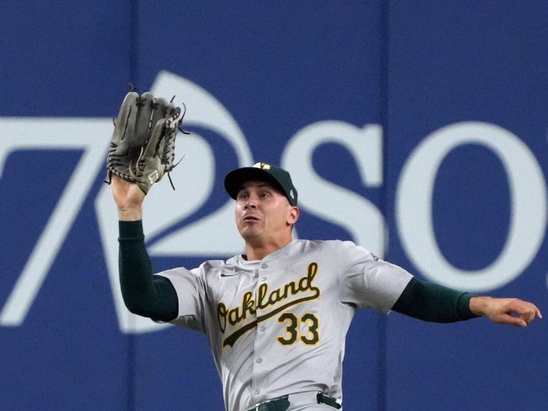 Jun 29, 2024; Phoenix, Arizona, USA; Oakland Athletics outfielder JJ Bleday (33) makes the slding catch against the Arizona Diamondbacks in the fourth inning at Chase Field. Mandatory Credit: Rick Scuteri-USA TODAY Sports