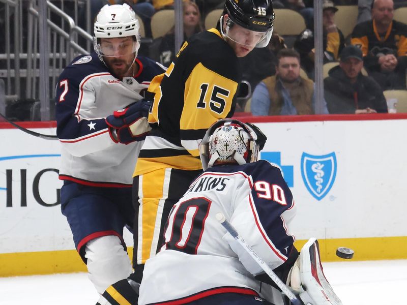 Mar 21, 2025; Pittsburgh, Pennsylvania, USA;  Columbus Blue Jackets goaltender Elvis Merzlikins (90) makes a save against Pittsburgh Penguins left wing Joona Koppanen (15) as Columbus center Sean Kuraly (7) defends during the third period at PPG Paints Arena. Mandatory Credit: Charles LeClaire-Imagn Images